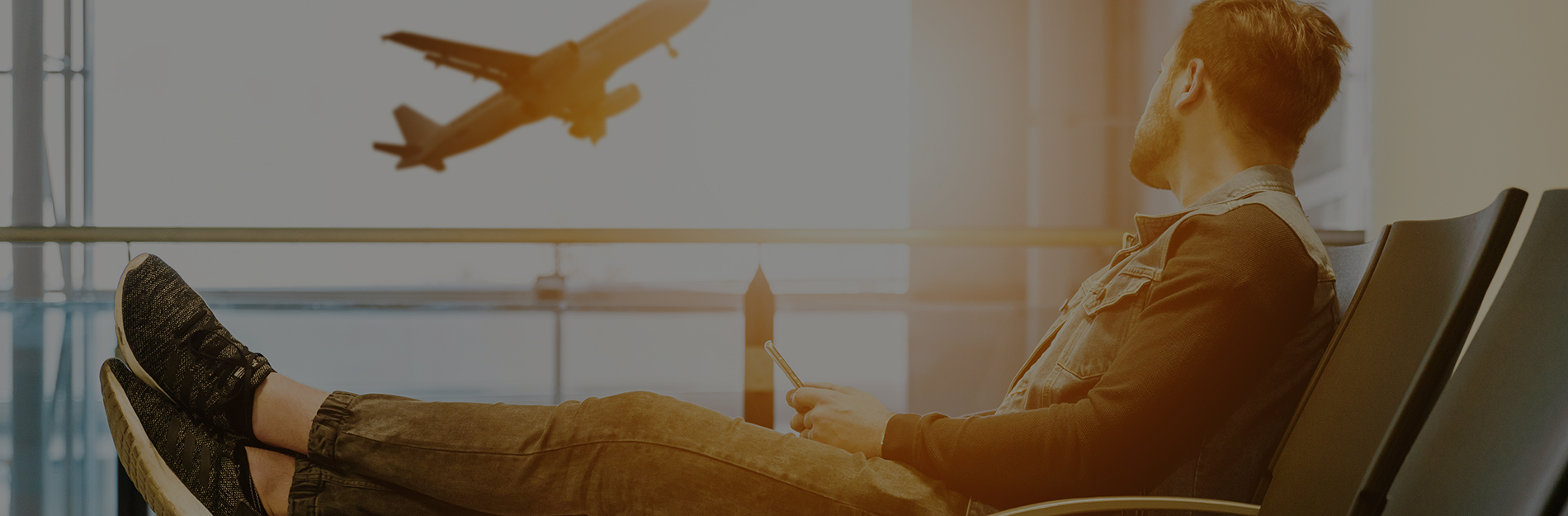 A man waiting at a gate for his flight at SeaTac airport