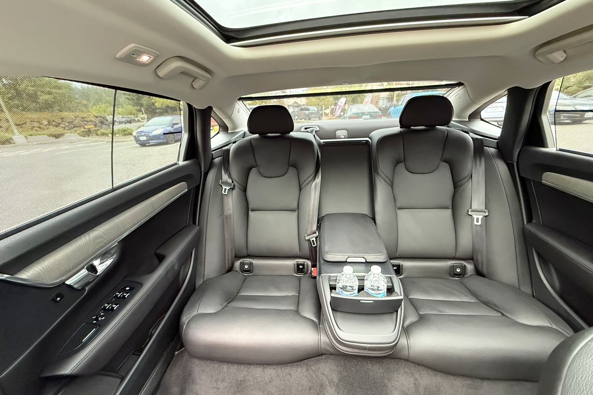 Interior of Starline's luxury sedan, black leather seatings with complimentary water