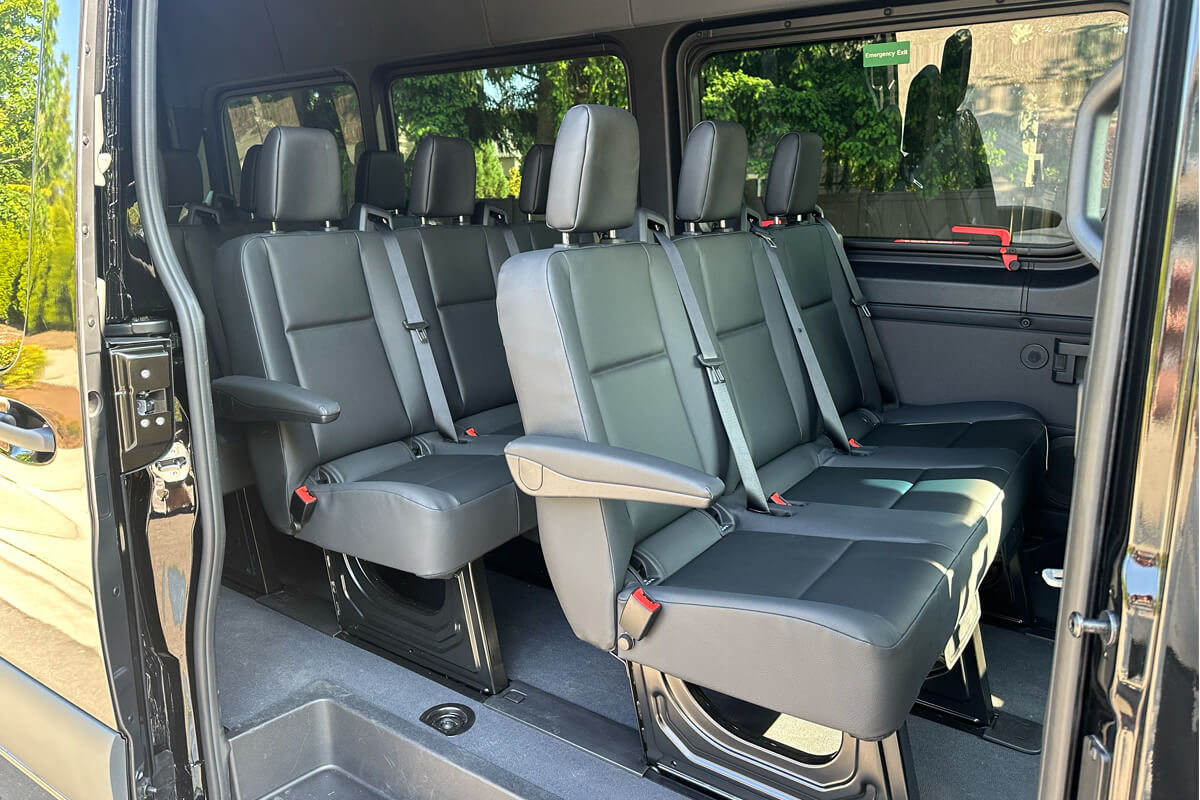 Inside our Sprinter van. Black leather seats with lots of leg room.