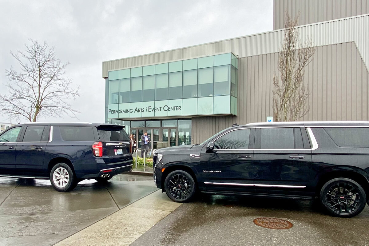 Starline's two black SUVs waiting for passengers at the Federal Way Performing Arts & Event Center