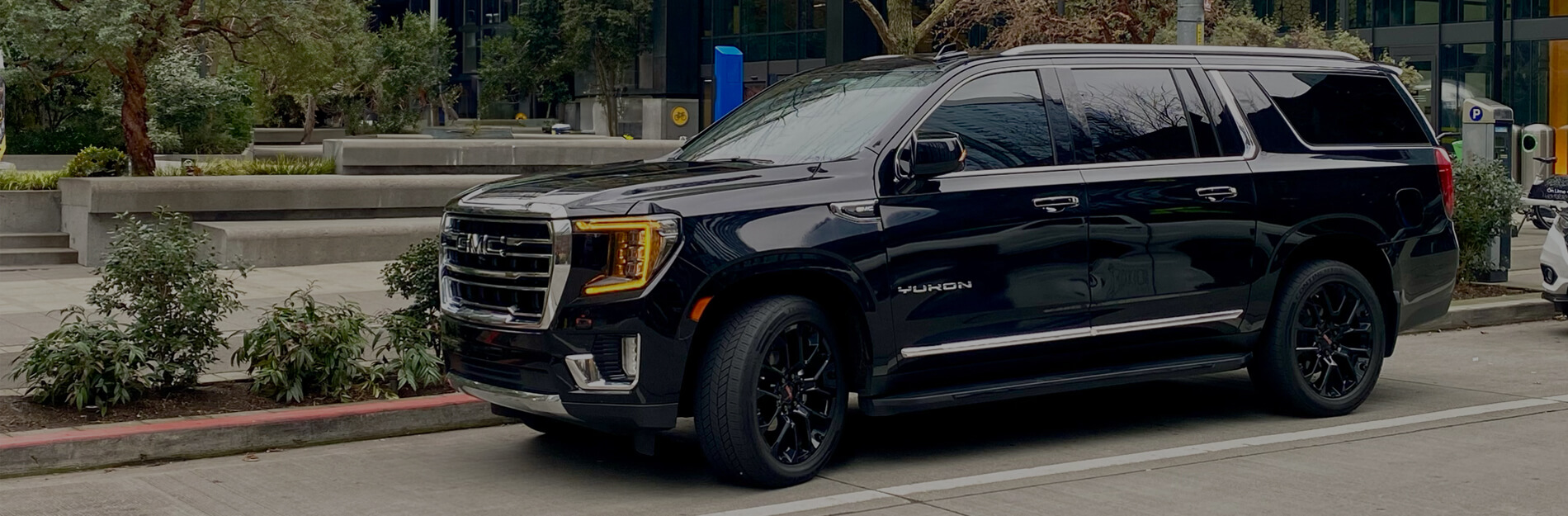 Starline's black SUV chauffeur vehicle parked on a downtown Seattle street.
