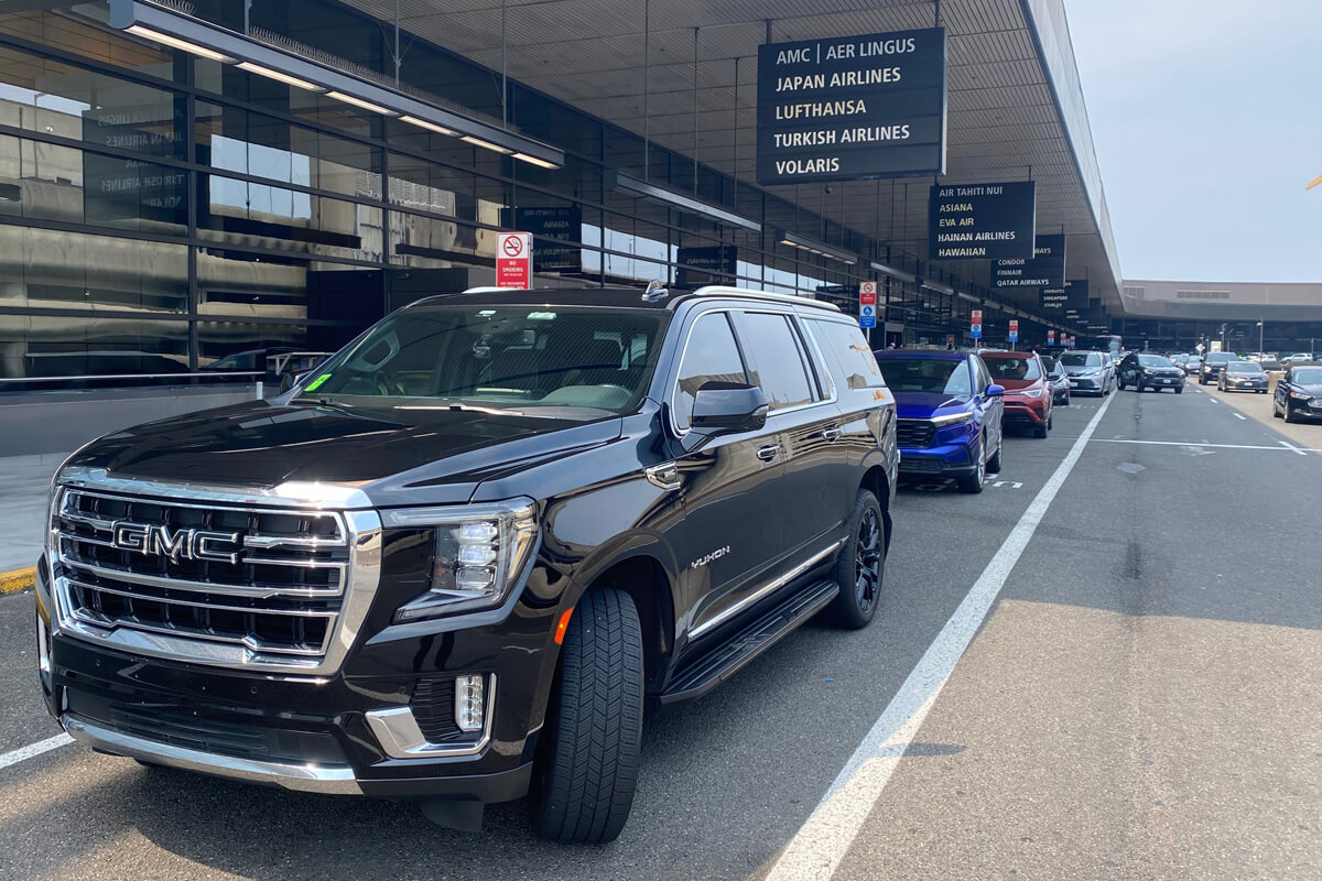 Black luxury SUV at Seattle–Tacoma International Airport providing private airport transfer service for Renton clients.