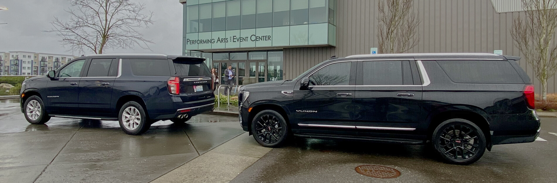 Starline's two black SUVs waiting for passengers at Federal Way Performing Arts Center