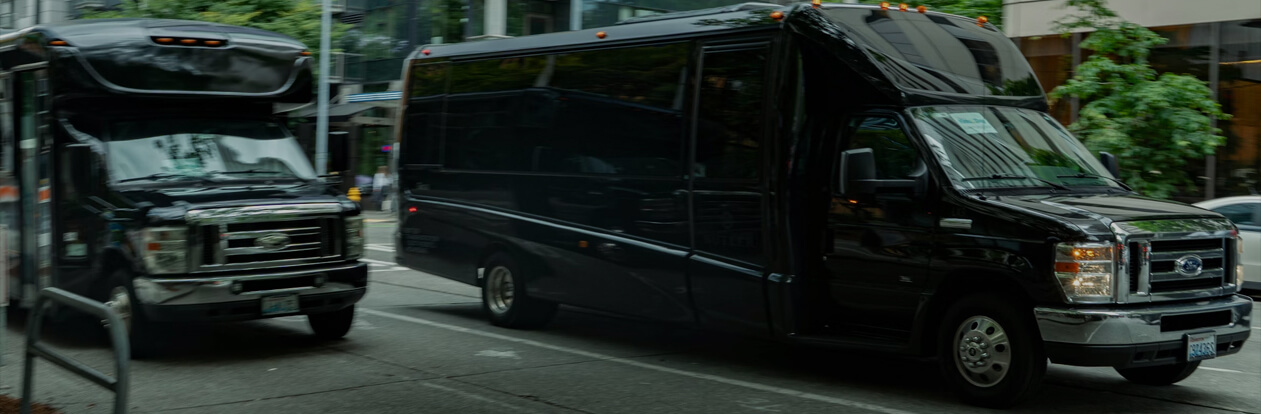 Airport shuttle vans driving along a downtown Seattle street