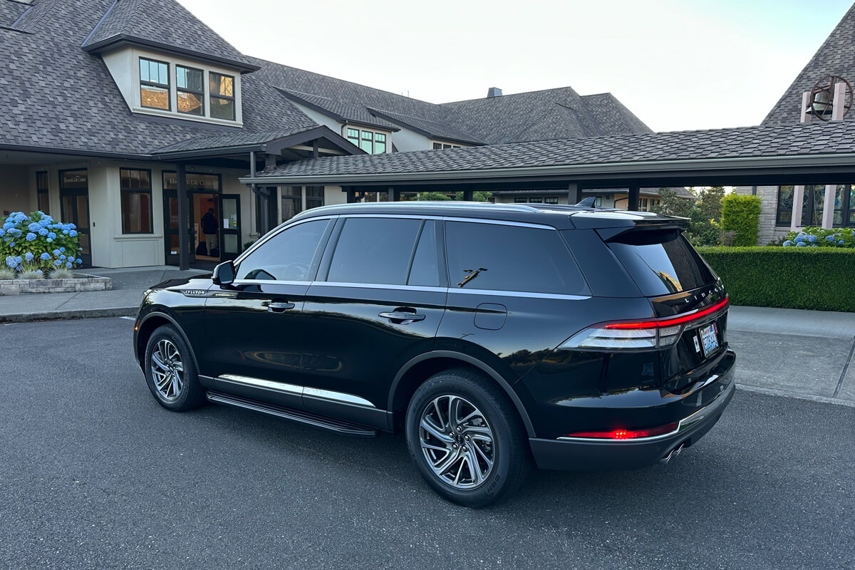 Black Lincoln SUV parked outside a Seattle event venue for private event transportation