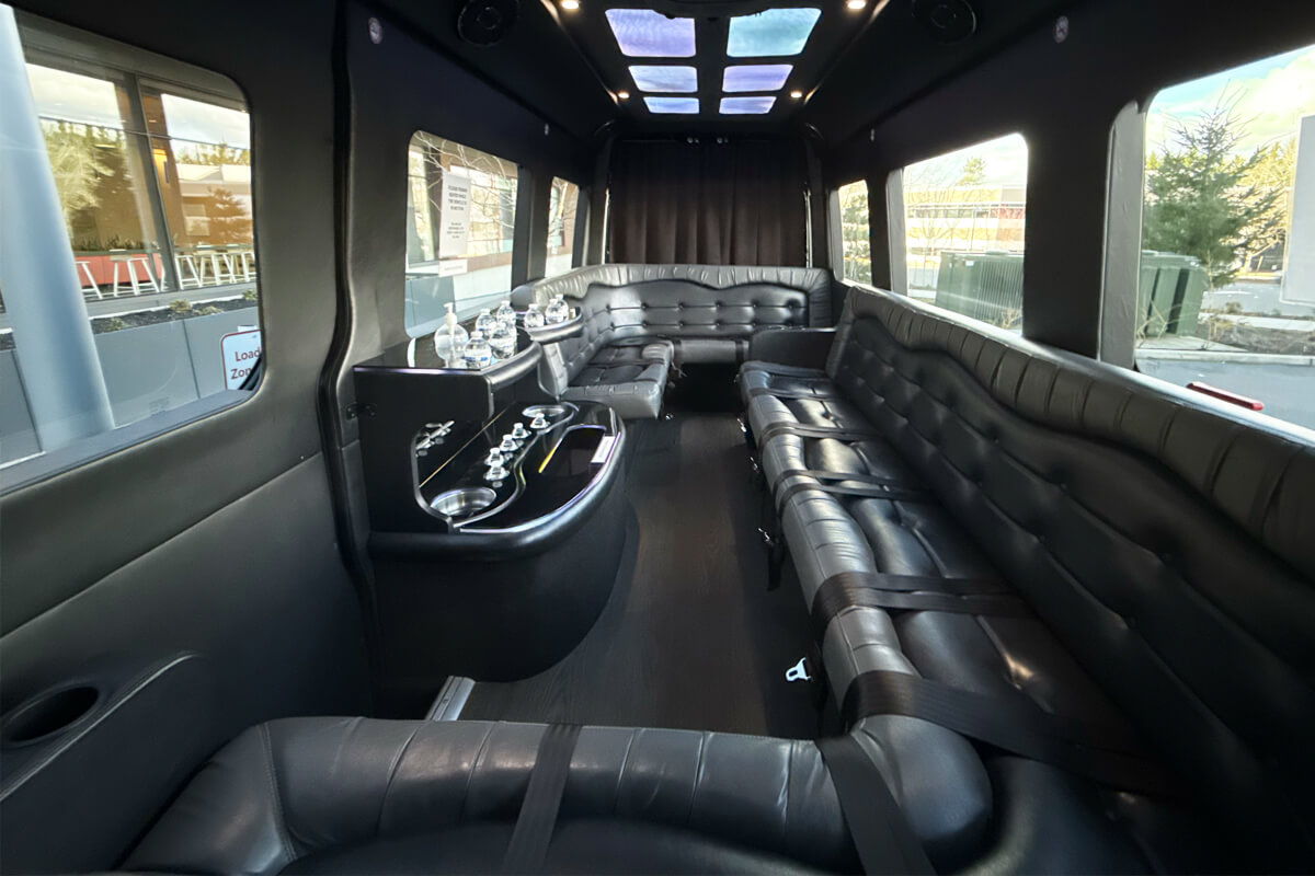 Interior of a Seattle party bus with wraparound leather seating and mood lighting for private events, group celebrations, and special occasion transportation.