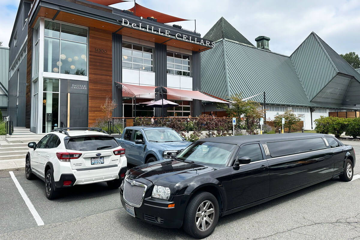 Black stretch limo parked outside DeLille Cellars in Woodinville during a private winery transportation outing