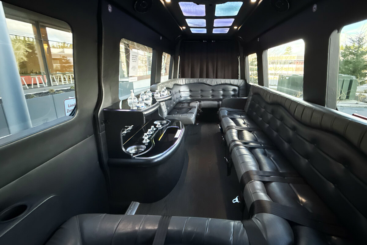 Interior of a luxury Sprinter Van with wraparound leather seating for private wine tour transportation