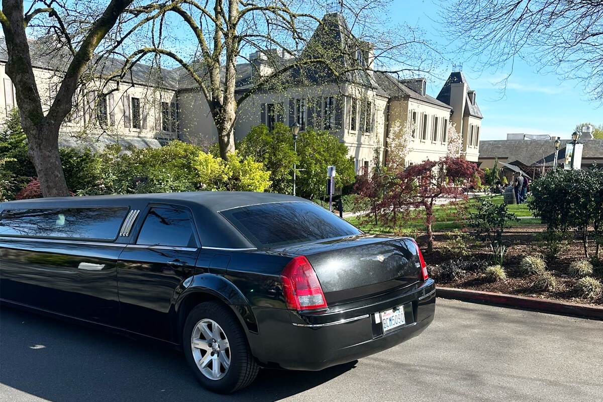 Black stretch limousine parked near Chateau Ste. Michelle for private Woodinville event transportation.