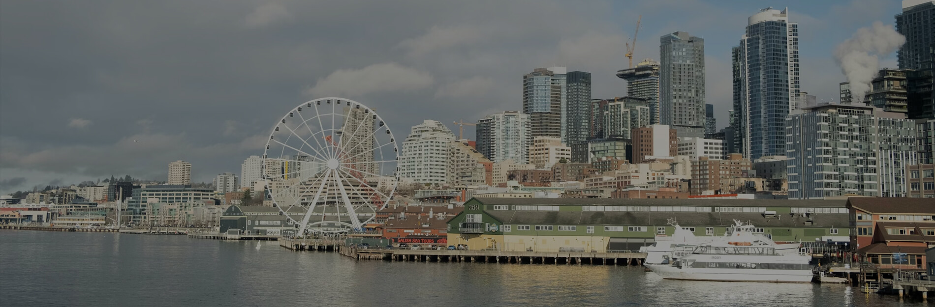 Seattle waterfront skyline and Great Wheel near Pier 66 for Seattle cruise transfer planning
