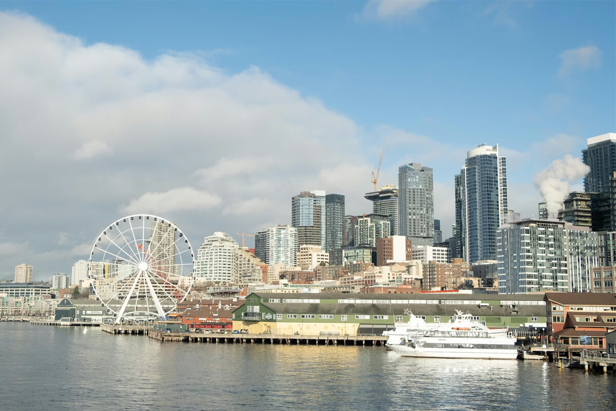Seattle waterfront skyline near Pier 66 cruise terminal with the Great Wheel and downtown high-rises