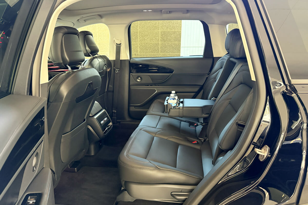 Spacious black SUV interior with rear seating for private transportation