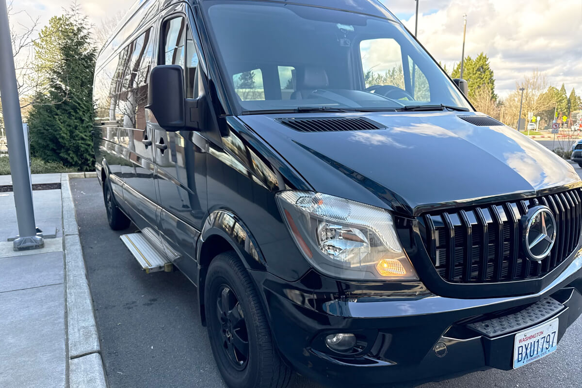 Starline black party bus parked curbside for private events, celebrations, and group transportation