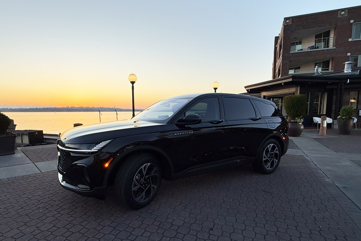 Black SUV parked near the waterfront for Des Moines limo service and local travel