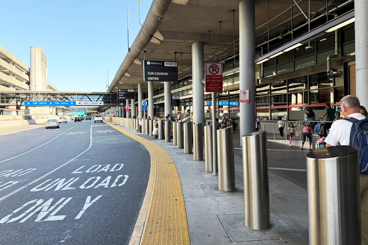 SeaTac Airport arrivals curbside pickup area with passenger loading lanes