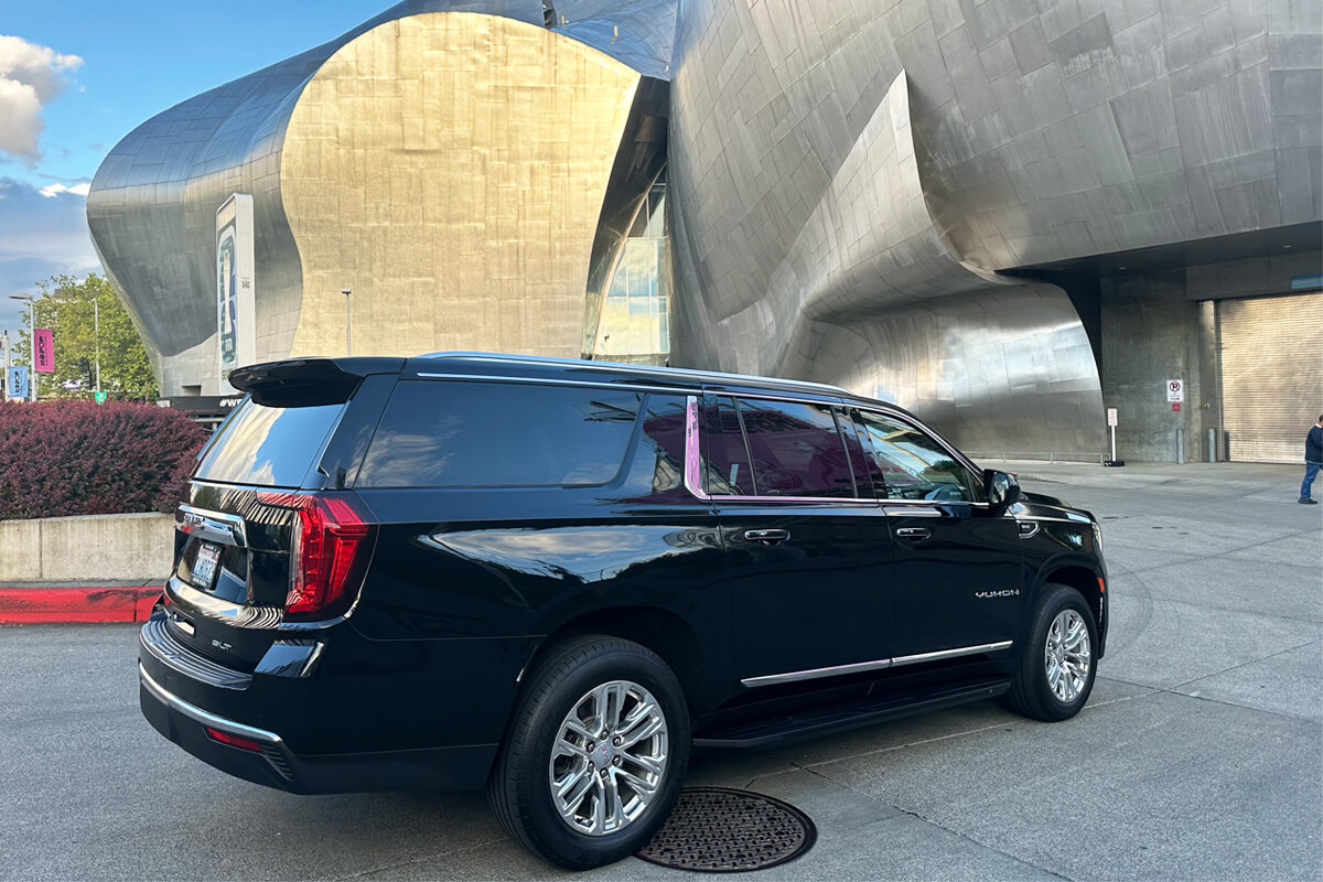 Black GMC Yukon outside Seattle Center for concert and private event transportation
