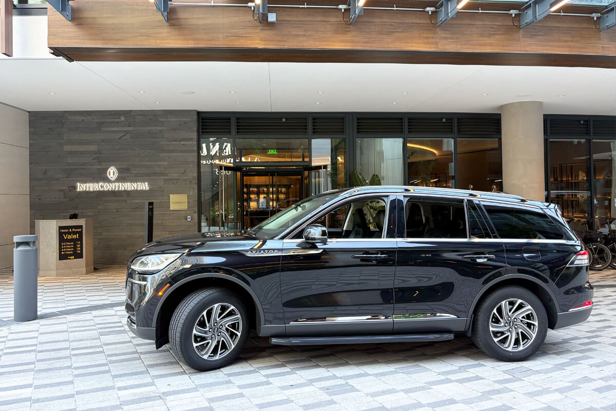Black Lincoln SUV at a hotel entrance for private town car service